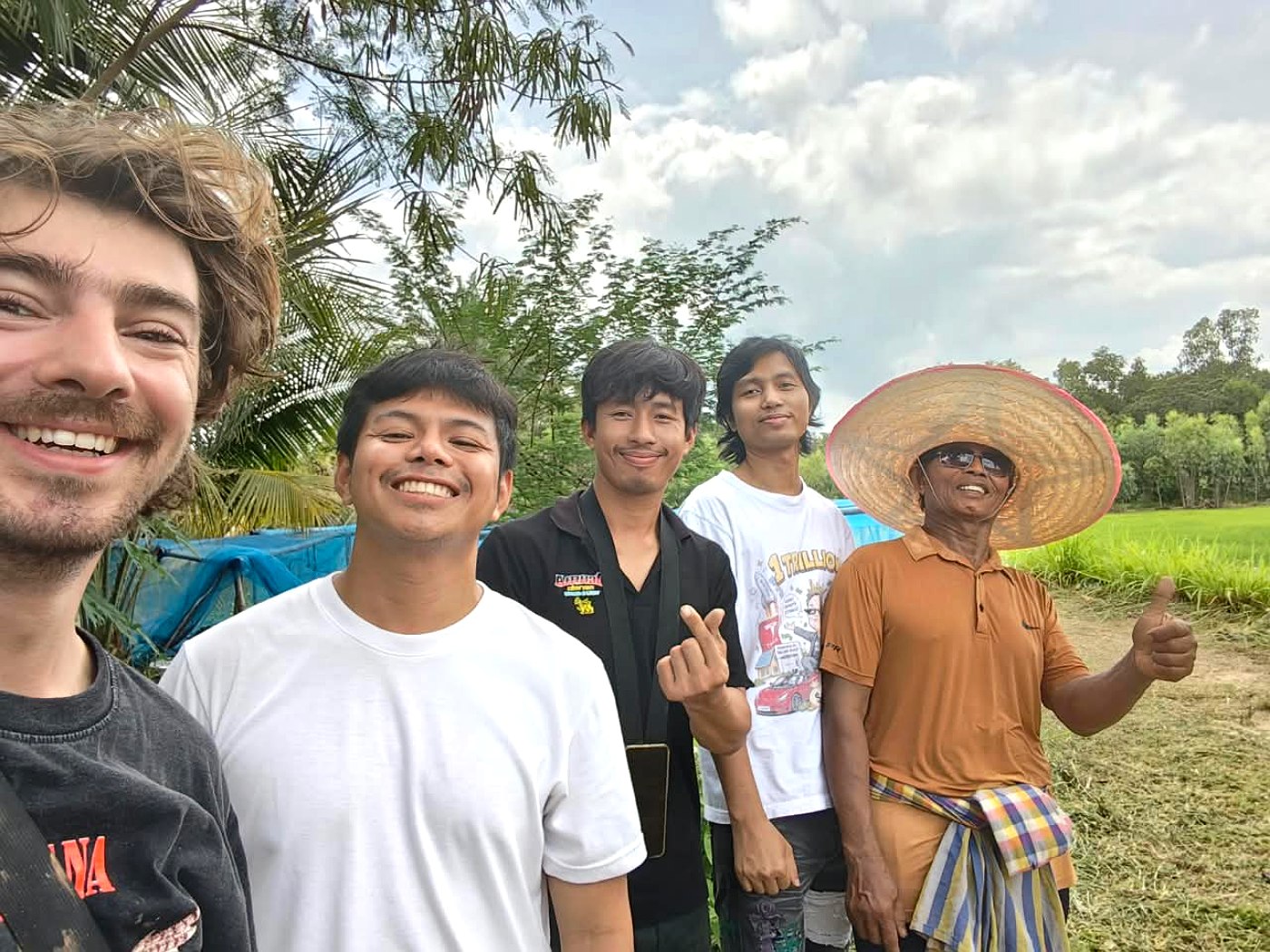 Theos and Toppy with the growers beside the cultivation basins in Amnat Charoen, Thailand